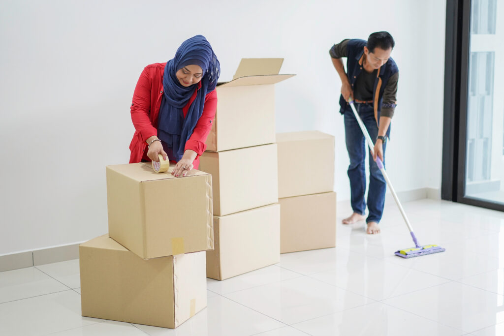 people packing and cleaning an apartment