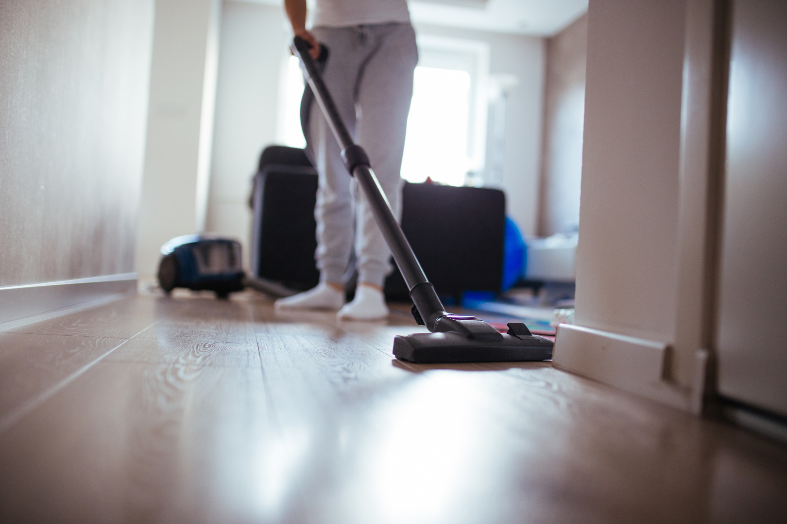 professional cleaner vacuuming floors