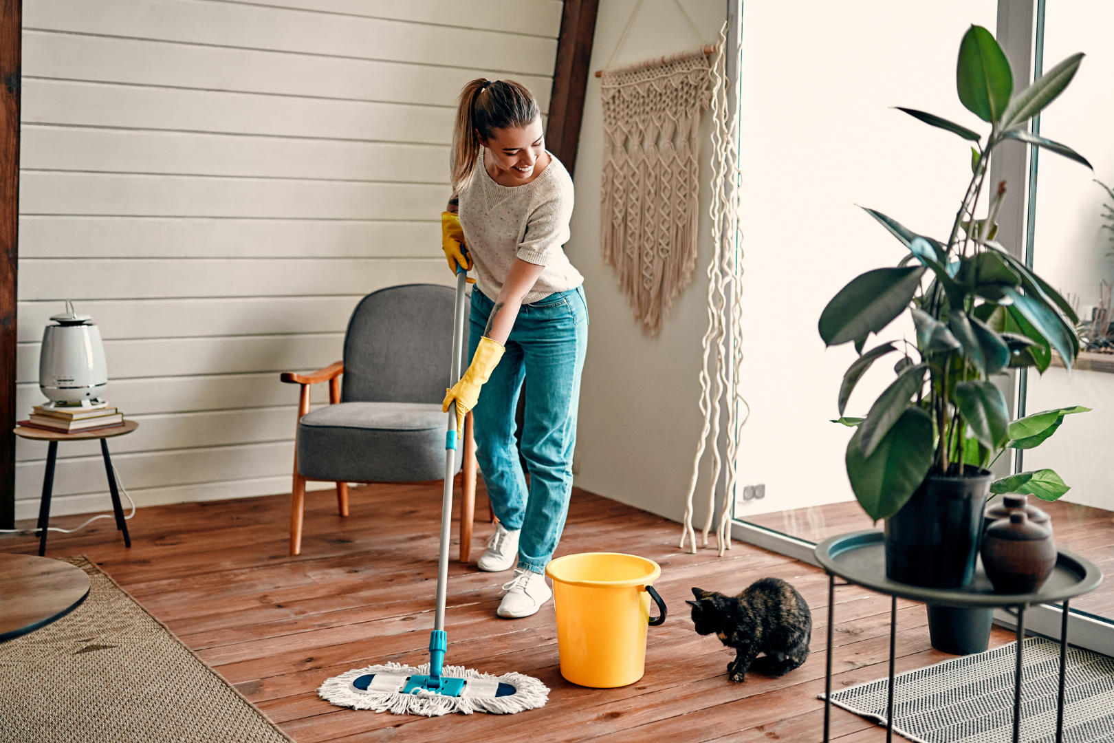 a professional cleaning lady mopping a laminate floor