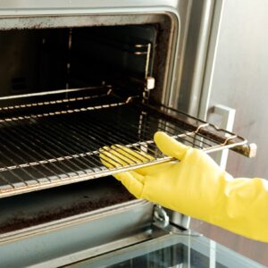 A side-by-side comparison of a dirty oven rack before cleaning and a spotless oven rack after deep cleaning.